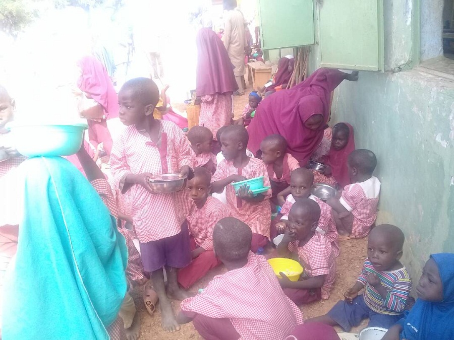 Children take meals at a school in Zamfara
